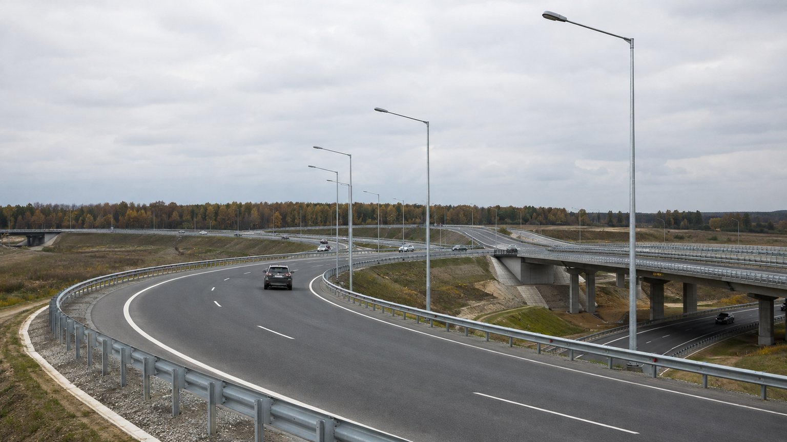 12m galvanized street light poles following a curved highway interchange ramp